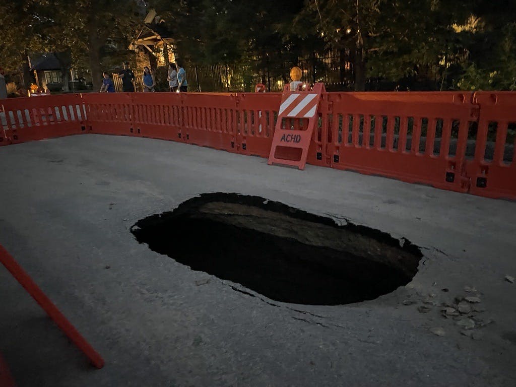 Night observation of sink hole with barricades on August 24