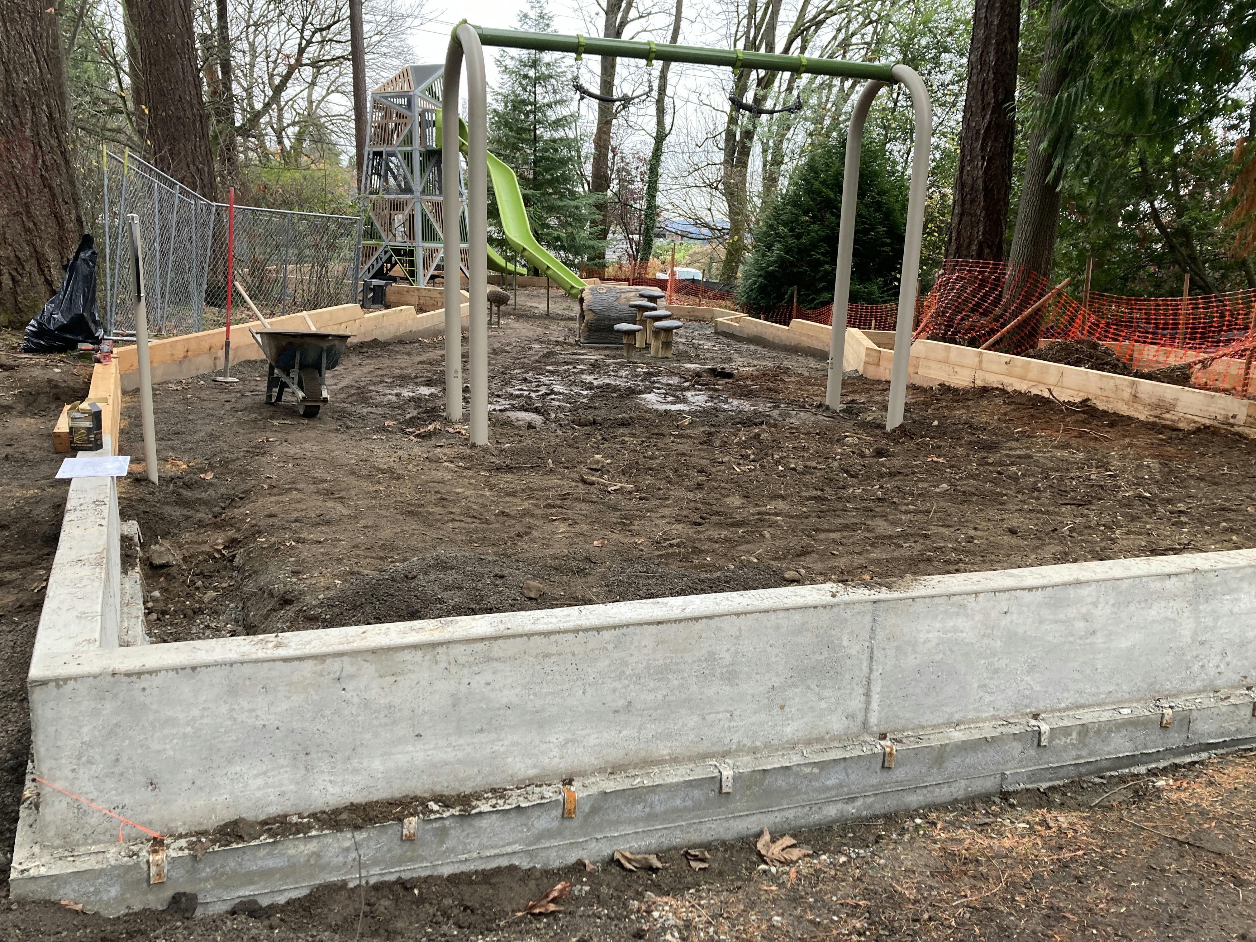 Concrete curb at the north end of the play area
