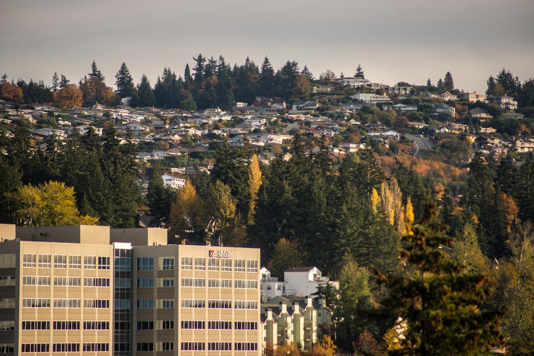 Photo of T-Mobile buildings with houses on a hill in the background