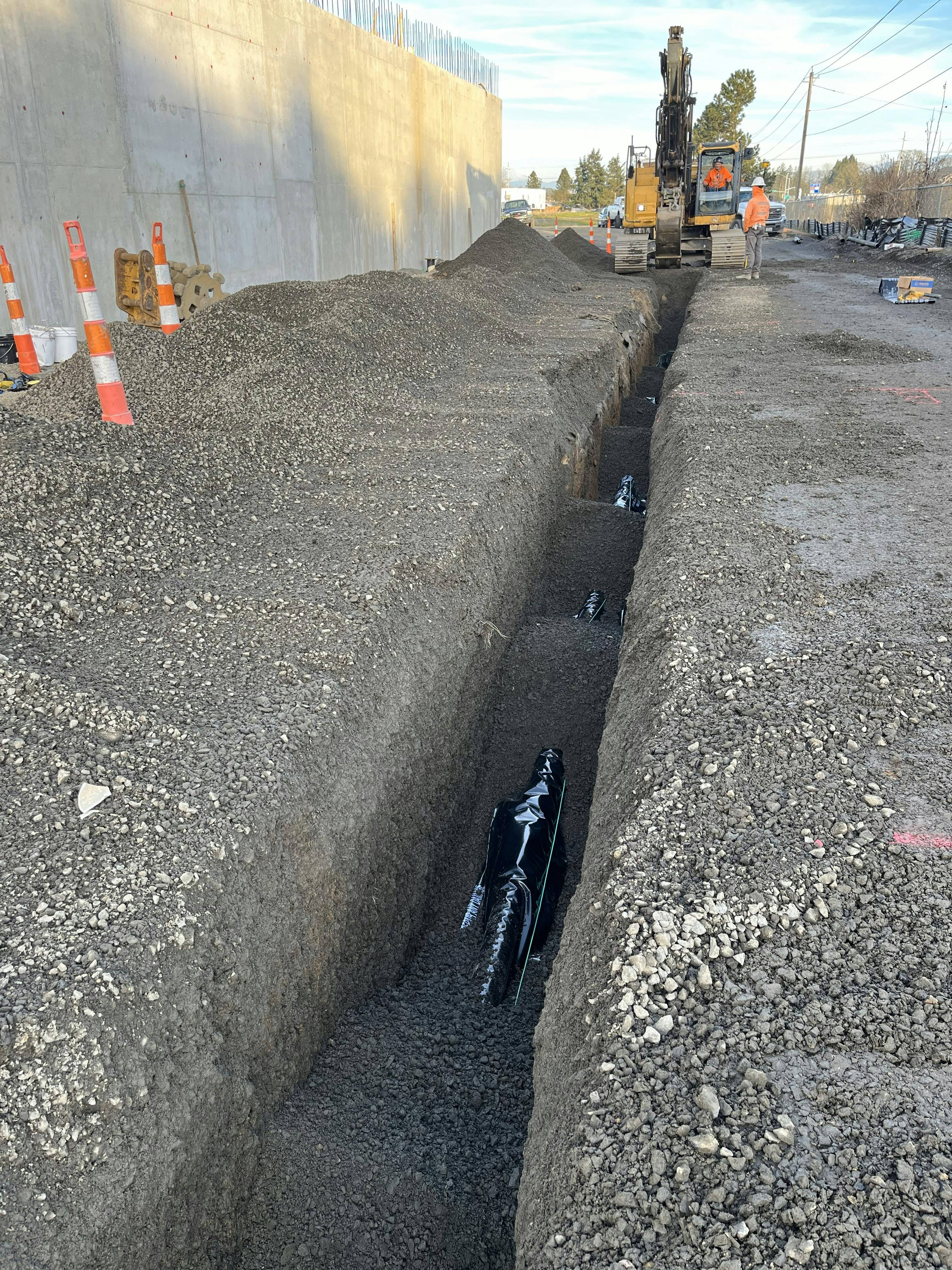 last runs of piping from one structure to another getting placed.